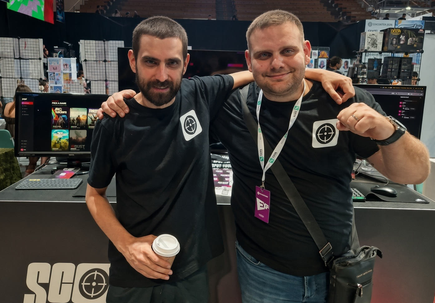The two founders of Scoped Studio, arm in arm at the Scoped stand